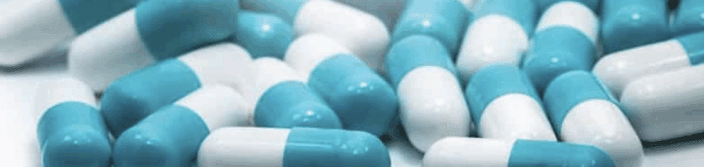 Blue and white Serax capsules scattered on a surface, used to treat anxiety and insomnia.